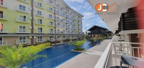 JC SpaceRentals 127B Amani Grand Resort Residences, balcony pool view, Ground floor, 5 mins frm airport, free wifi, Netflix